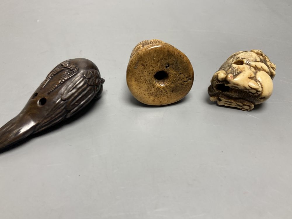 Two Japanese staghorn netsuke of lion dogs, two ivory netsuke of a lotus pod and a manju, 19th century and two modern wood netsuke